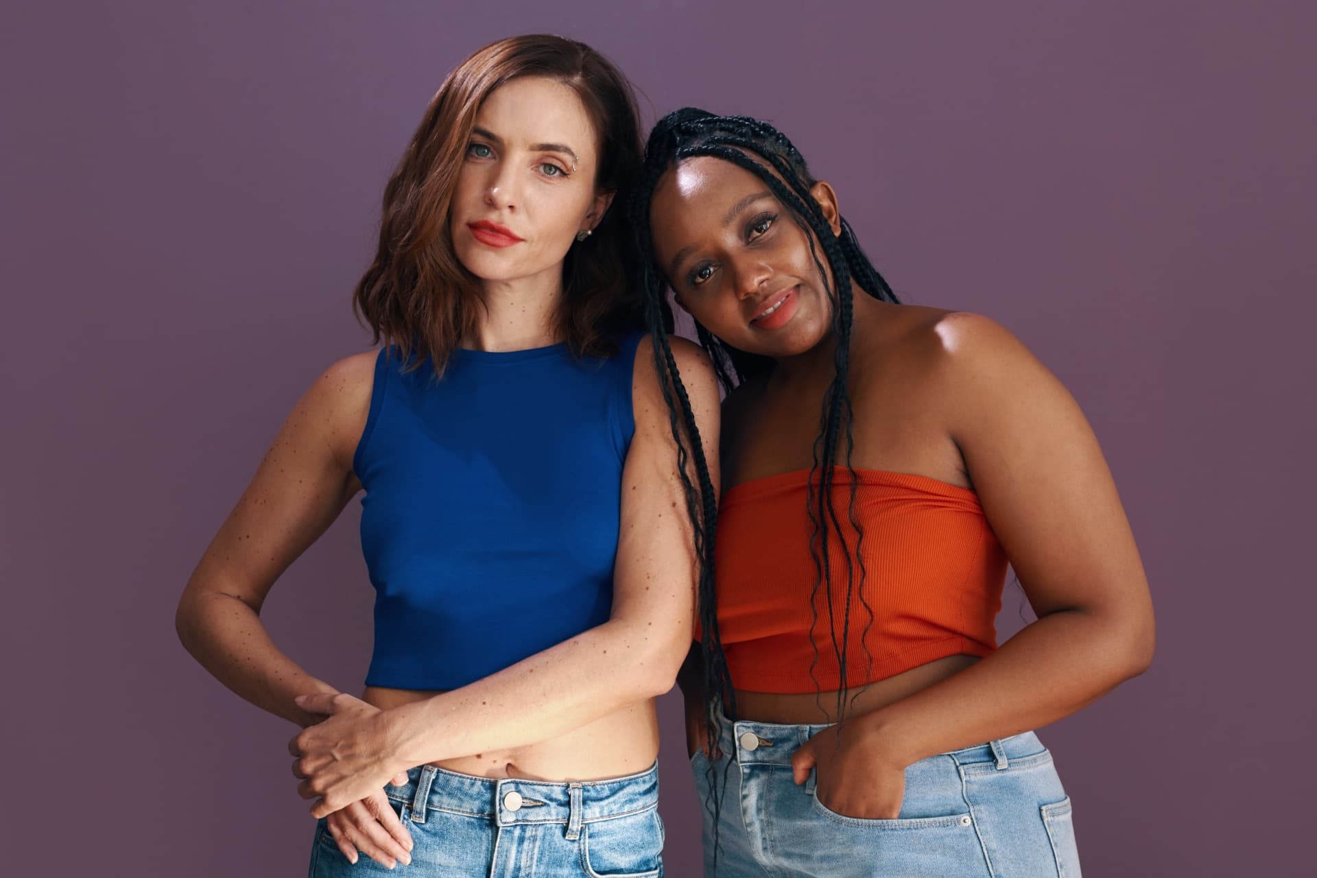 Two models of different body types standing side by side, photographed in black and white